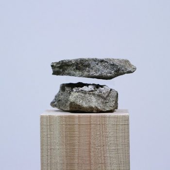 Photographs of Transparent Acrylic Perfectly Sandwiched Between Stacked Stones