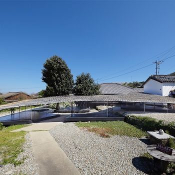 An Elongated Roof Extends from an Abandoned Home to Form an Island Kitchen on Teshima